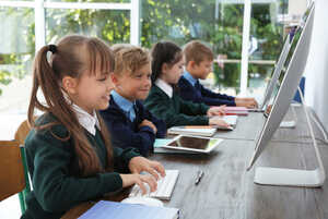 Children in a classroom using desktop computers