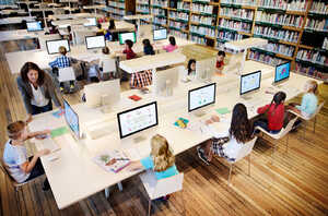 classroom with students using a desktop computers