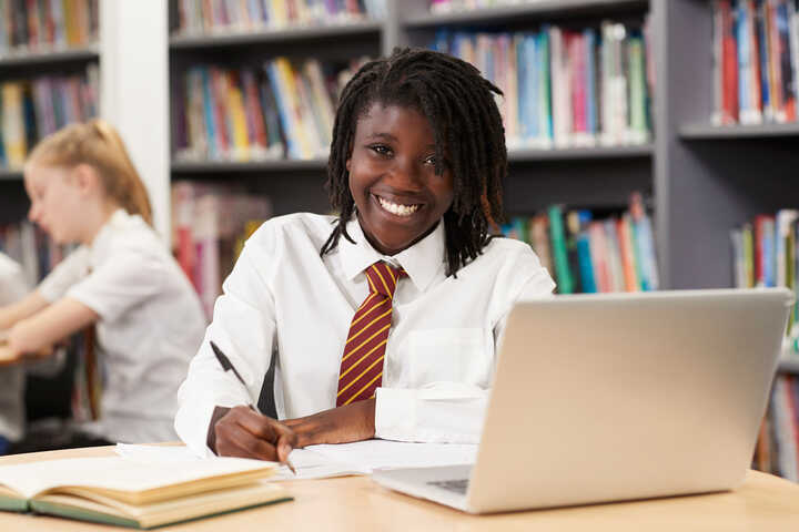 girl using laptop in school