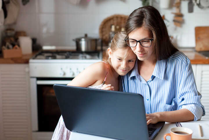 parent and their child with laptop