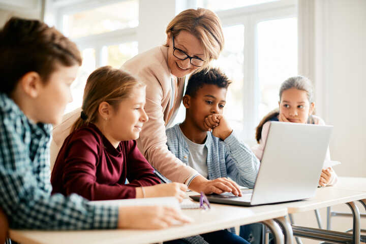 teacher and students with laptop