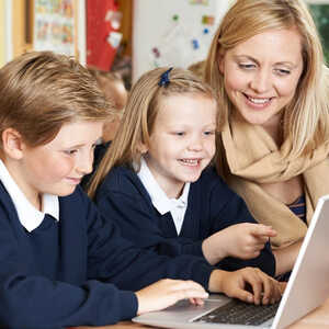 teacher helping students on a laptop teacher helping students on a laptop