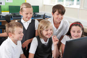 children using a computer in a classroom