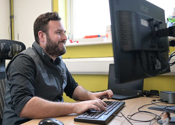 teacher helping students with IT work