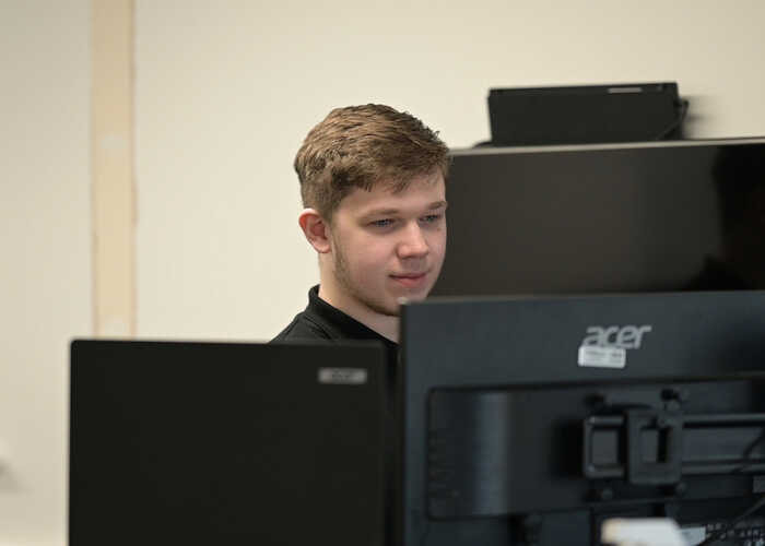 teacher helping students with IT work teacher helping students with IT work