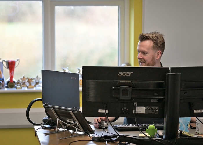 teacher helping students with IT work
