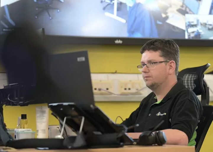 teacher helping students with IT work