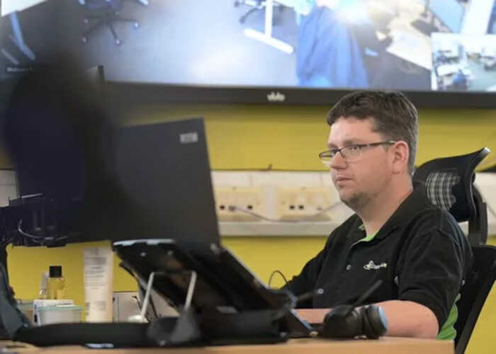 teacher helping students with IT work teacher helping students with IT work