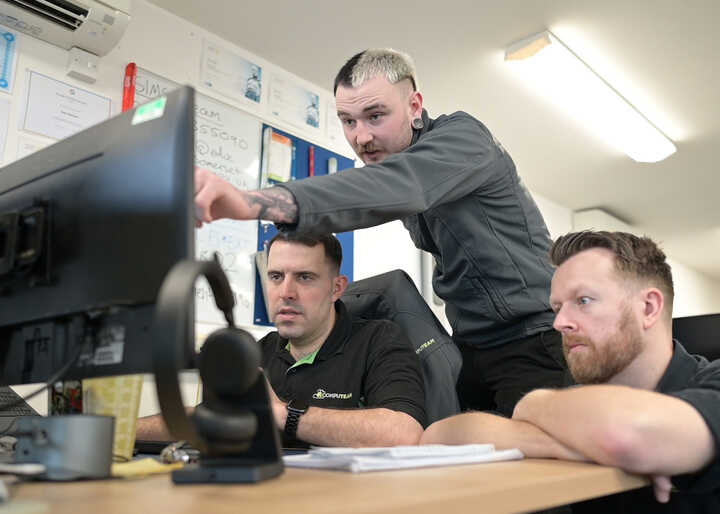 teacher helping students with IT work