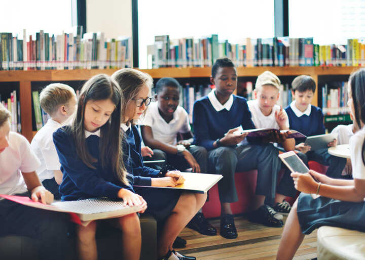 teacher helping students with IT work