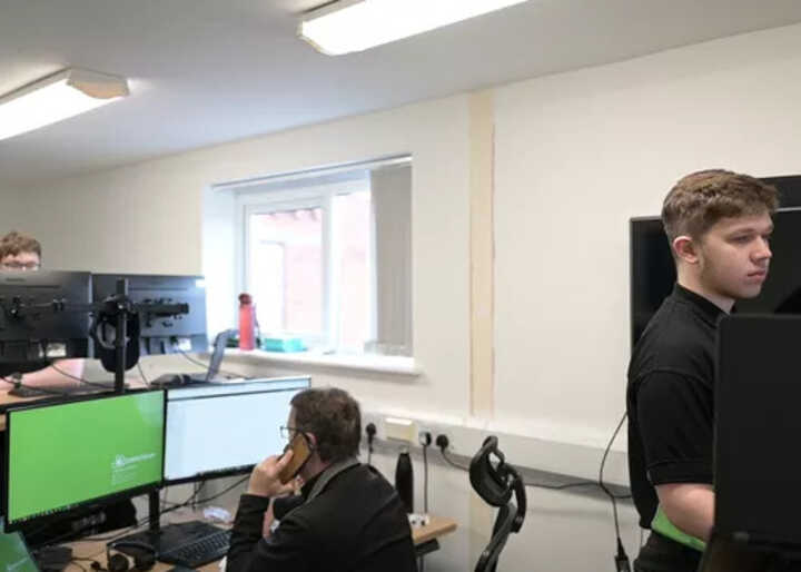 teacher helping students with IT work