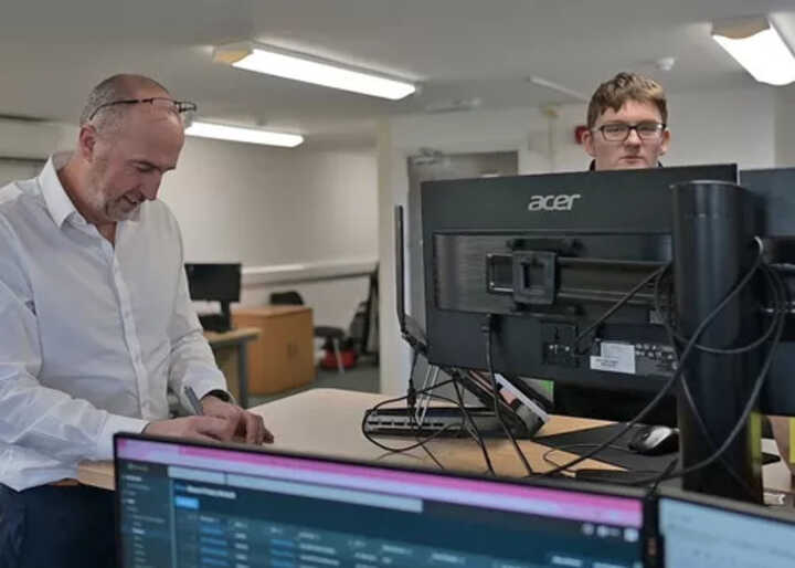 teacher helping students with IT work