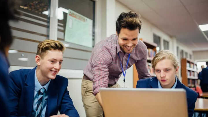 teacher and students with laptop